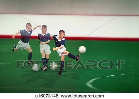 Multiple exposure of boy kicking soccer ball View Large Photo Image Stock Photo - Multiple exposure of boy kicking soccer ball. Fotosearch