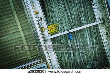 Stock Image - Old door with cracked glass. Fotosearch