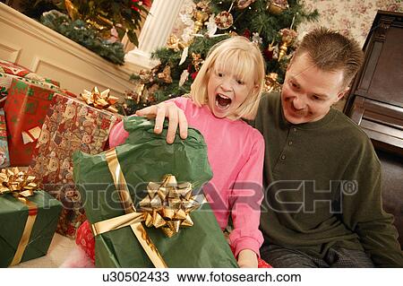 Opening a present View Large Photo Image Stock Image - Opening a present. Fotosearch