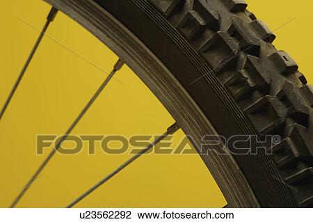 Part of a bicycle wheel against a yellow background View Large Photo Image Stock Image - Part of a bicycle wheel against a yellow background. Fotosearch