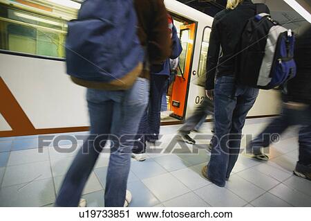 Stock Image - Passengers getting on and off subway. Fotosearch