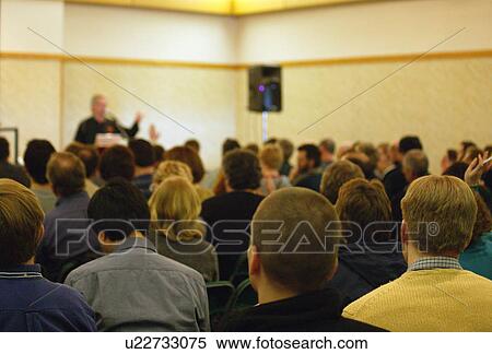 Stock Photography - People asking questions in a meeting. Fotosearch