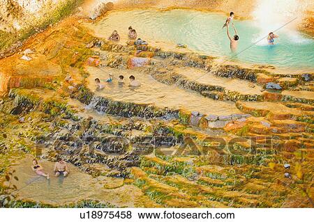 Stock Photo - People swimming in a natural hot spring. Fotosearch