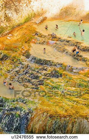 Stock Photography - People swimming in a natural hot spring. Fotosearch