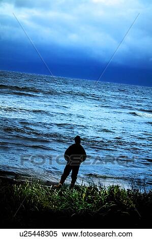 Stock Photography - Person gazing out to sea. Fotosearch