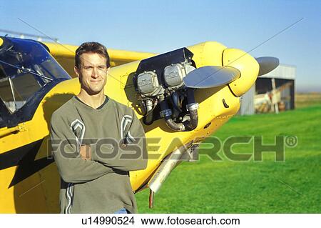 Picture - Pilot with his airplane. Fotosearch