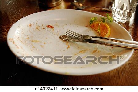 Stock Image - Plate with utensils and garnish on it. Fotosearch