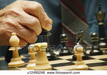 Playing a game of chess View Large Photo Image Stock Photograph - Playing a game of chess. Fotosearch