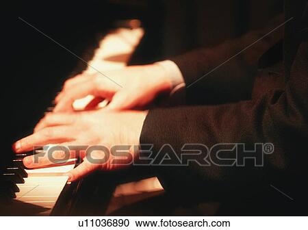 Stock Image - Playing the piano. Fotosearch