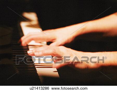 Playing the piano View Large Photo Image Stock Photograph - Playing the piano. Fotosearch