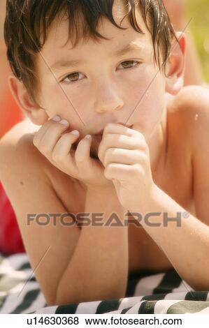 Stock Photo - Portrait of a boy drying off in the sun. Fotosearch