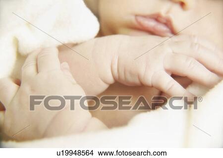 Picture - Portrait of a newborn's hands and mouth. Fotosearch