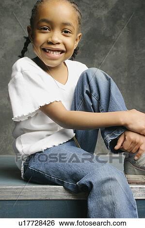 Portrait of confident little girl sitting View Large Photo Image Stock Photograph - Portrait of confident little girl sitting. Fotosearch