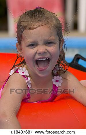 Portrait of little girl playing in Swimming Pool View Large Photo Image Stock Photo - Portrait of little girl playing in Swimming Pool. Fotosearch