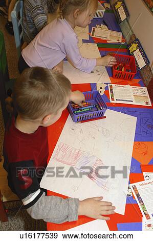 Preschool age children drawing Halloween pictures in class View Large Photo Image Stock Photo - Preschool age children drawing Halloween pictures in class. Fotosearch
