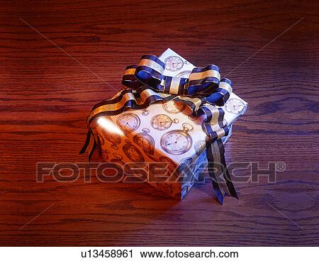 Stock Image - Present with blue and gold bow. Fotosearch