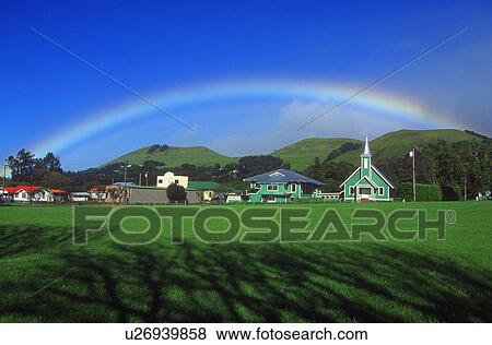 Stock Photo - Rainbow over the village. Fotosearch