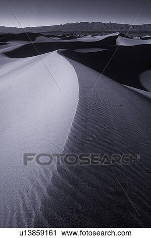 Ripples in desert sand with mountain in background View Large Photo Image Stock Image - Ripples in desert sand with mountain in background. Fotosearch