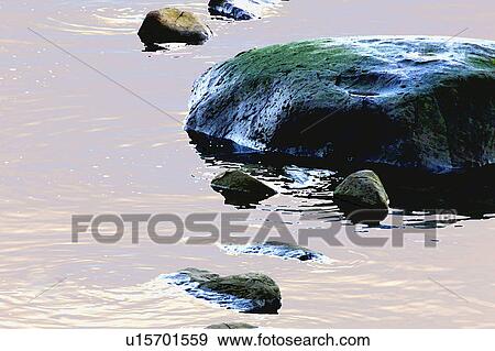 Rocks in water View Large Photo Image Stock Photo - Rocks in water. Fotosearch