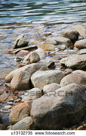Rocks on the shore line View Large Photo Image Stock Photography - Rocks on the shore line. Fotosearch