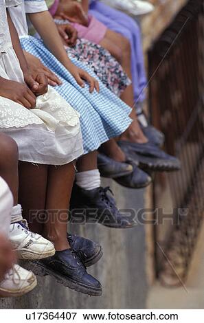 Stock Photo - Row of native children and their shoes. Fotosearch