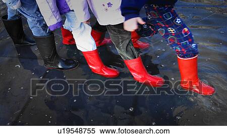 Stock Photography - Rubber boots in puddle. Fotosearch