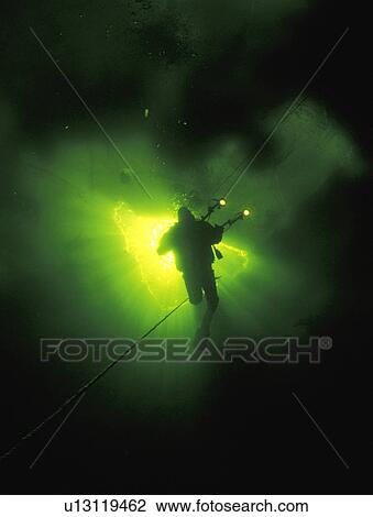 Stock Image - Scuba diver in underwater cave. Fotosearch