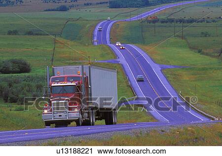 Stock Image - Semi truck on highway on overcast day. Fotosearch