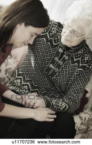 Stock Photograph - Senior and Woman praying. Fotosearch