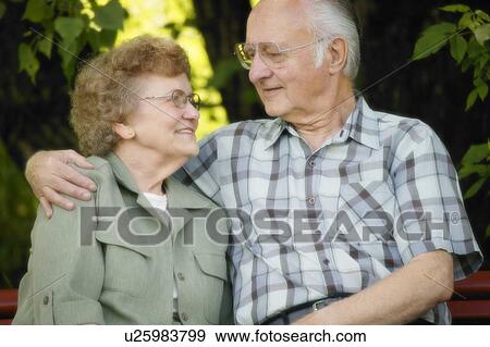 Senior couple sitting on bench View Large Photo Image Stock Photo - Senior couple sitting on bench. Fotosearch