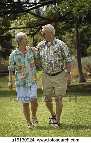 Senior couple walking in field View Large Photo Image Picture - Senior couple walking in field. Fotosearch