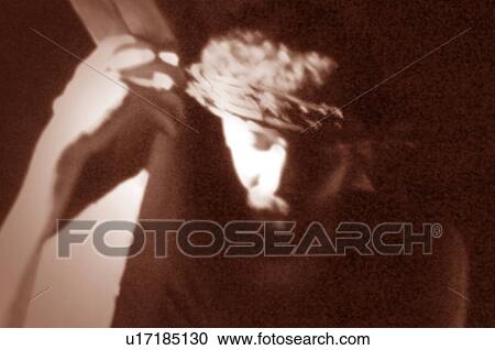 Stock Image - Sepia portrait of Christ bearing the cross. Fotosearch