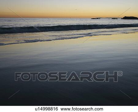 Stock Photograph - Shoreline at sunset. Fotosearch