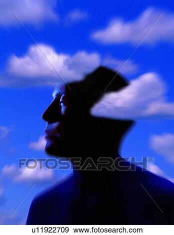 Stock Photo - Silhouette of man's head with cloud background. Fotosearch
