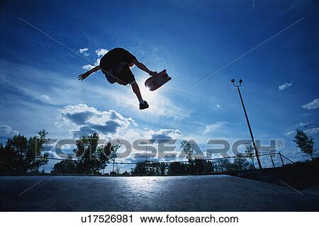 Skateboarder jumping in skate park View Large Photo Image Stock Image - Skateboarder jumping in skate park. Fotosearch