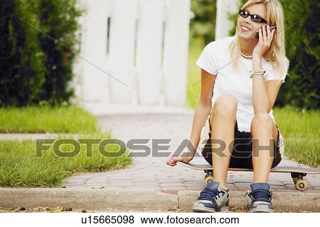 Skater talks on the phone View Large Photo Image Stock Photo - Skater talks on the phone. Fotosearch
