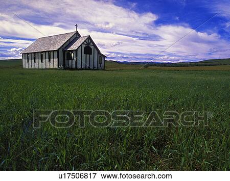 Stock Photo - Small country church in grass field. Fotosearch