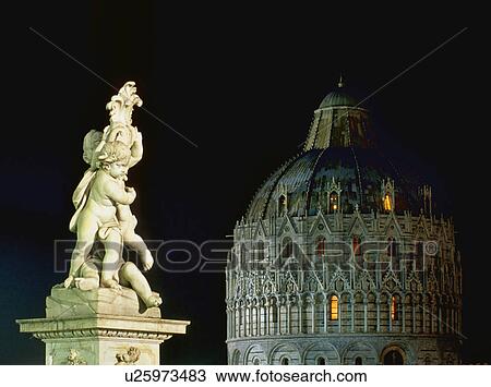 Stock Image - Statue near cathedral at night. Fotosearch