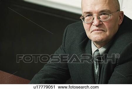 Stock Image - Stern looking older man. Fotosearch