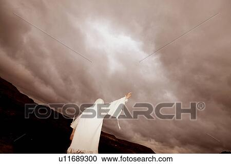 Stock Image - Stretching a hand towards heaven. Fotosearch
