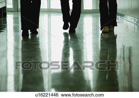 Stock Photograph - Students walk down hallway. Fotosearch