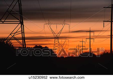 Stock Image - Sunset by parallel power lines. Fotosearch