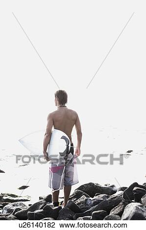 Surfer looking out to sea View Large Photo Image Stock Image - Surfer looking out to sea. Fotosearch