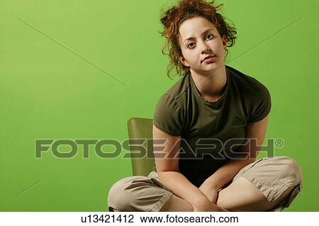 Teenage girl sits in a chair View Large Photo Image Stock Image - Teenage girl sits in a chair. Fotosearch