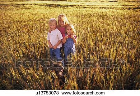 Stock Photo - Three children standing in a field of wheat. Fotosearch