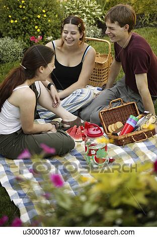 Three teenage friends having a picnic View Large Photo Image Stock Photo - Three teenage friends having a picnic. Fotosearch
