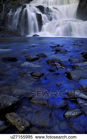 Stock Photography - Time delay of small waterfall into rocky creek. Fotosearch