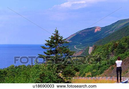Tourist taking a picture of a mountain scene and ocean View Large Photo Image Stock Image - Tourist taking a picture of a mountain scene and ocean. Fotosearch