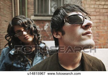 Trendy couple wearing sunglasses View Large Photo Image Stock Photo - Trendy couple wearing sunglasses. Fotosearch