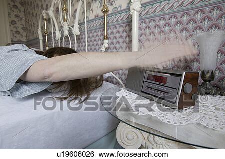 Turning off the alarm clock View Large Photo Image Stock Photograph - Turning off the alarm clock. Fotosearch